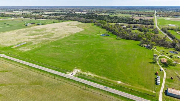 a view of a field with an ocean view