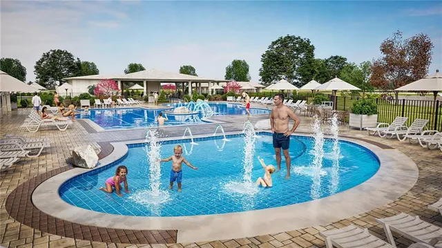 swimming pool view with a seating space