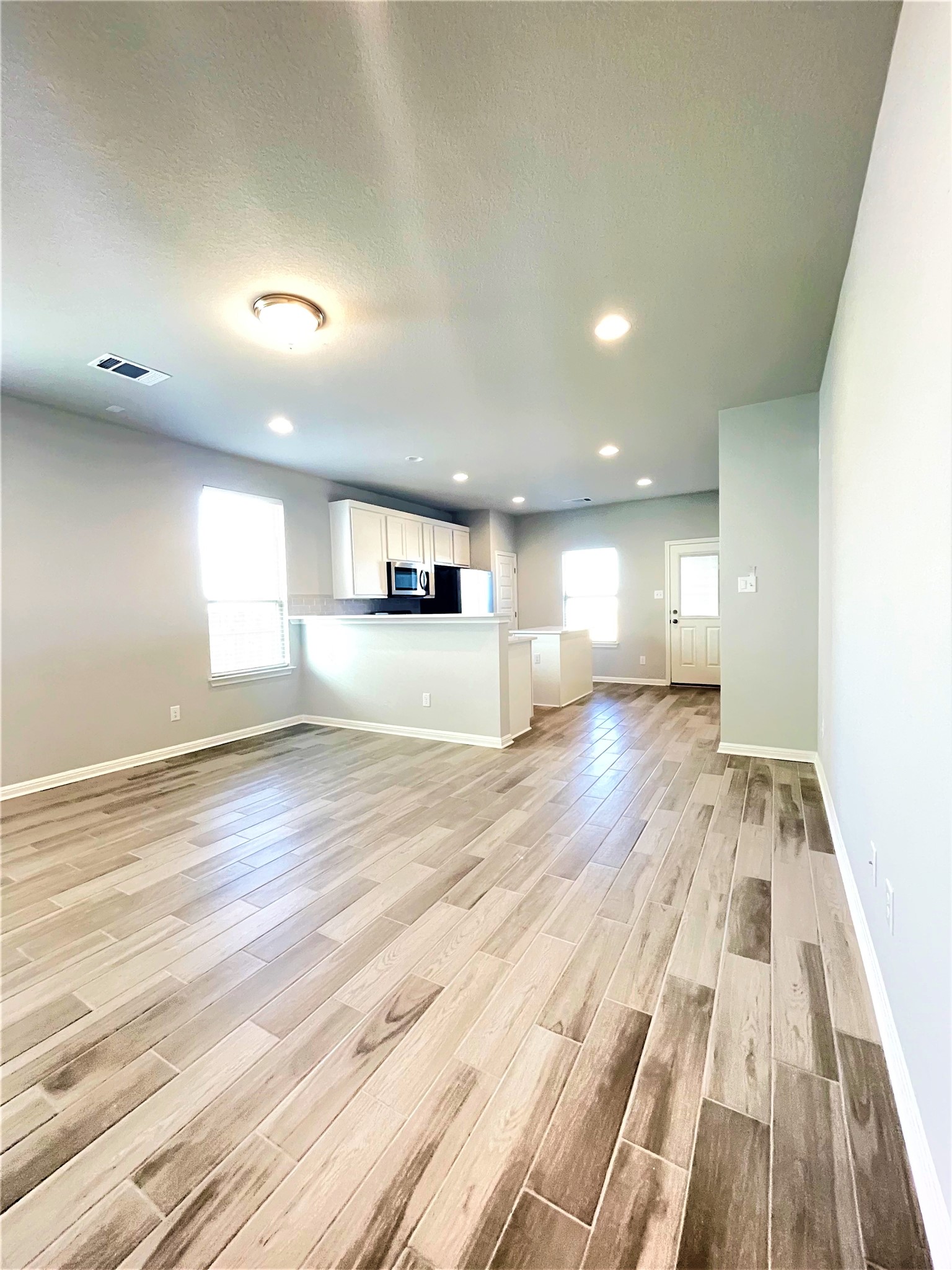 152 Old Stagecoach Road Jarrell, TX 76537 - Photo 8 of 21 Unfurnished living room with light wood finished floors and recessed lighting