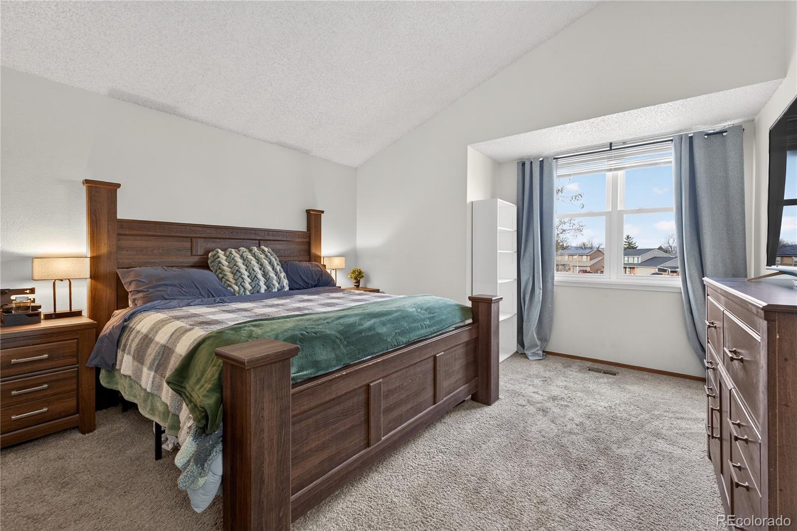 4730 Granby Way Denver, CO 80239 - Photo 16 of 27 a bedroom with a bed and a cabinets