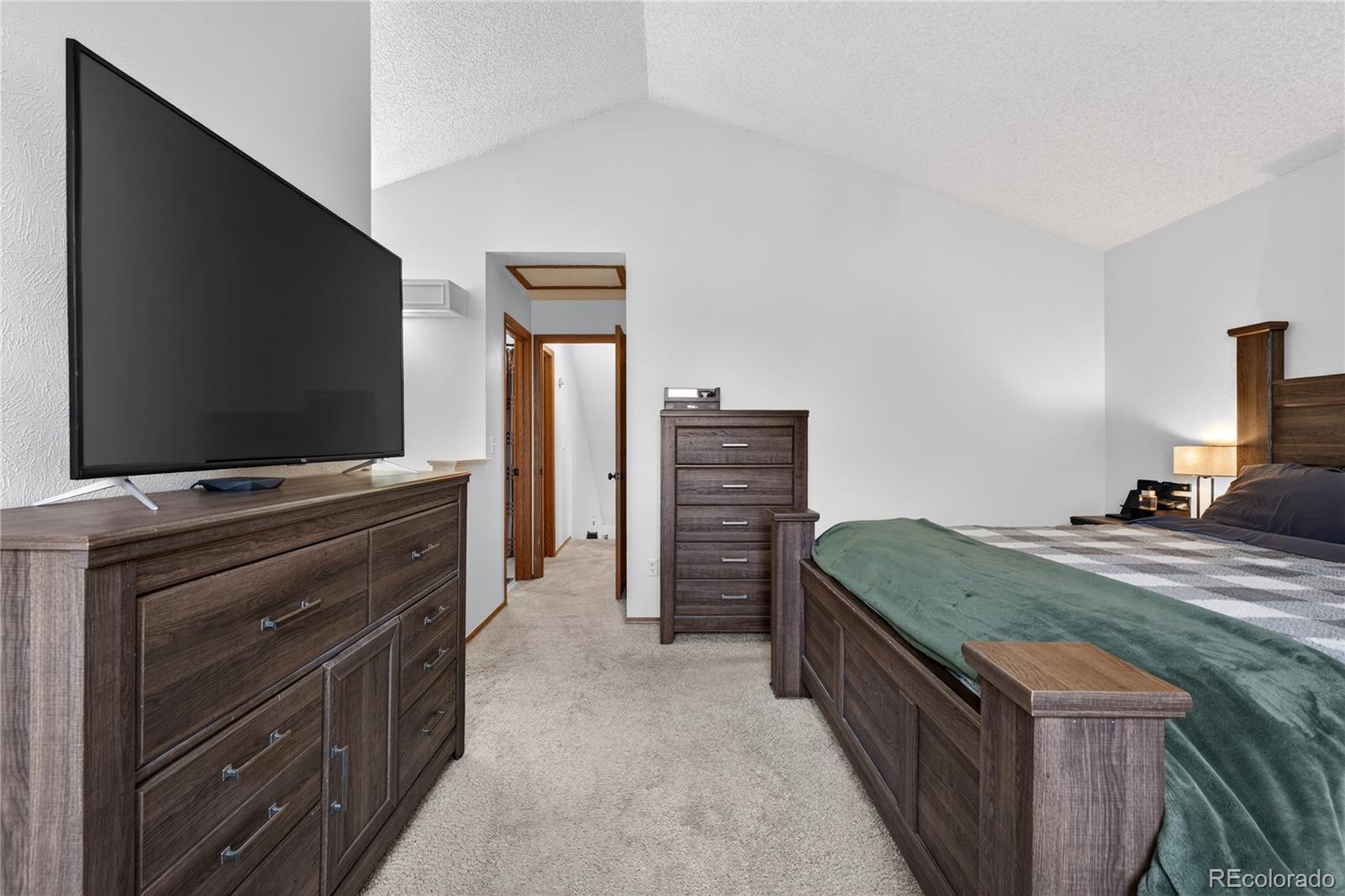 4730 Granby Way Denver, CO 80239 - Photo 17 of 27 a bedroom with furniture and a flat screen tv