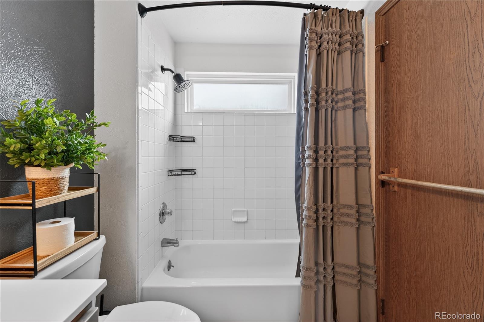 4730 Granby Way Denver, CO 80239 - Photo 20 of 27 a bathroom with a tub and shower