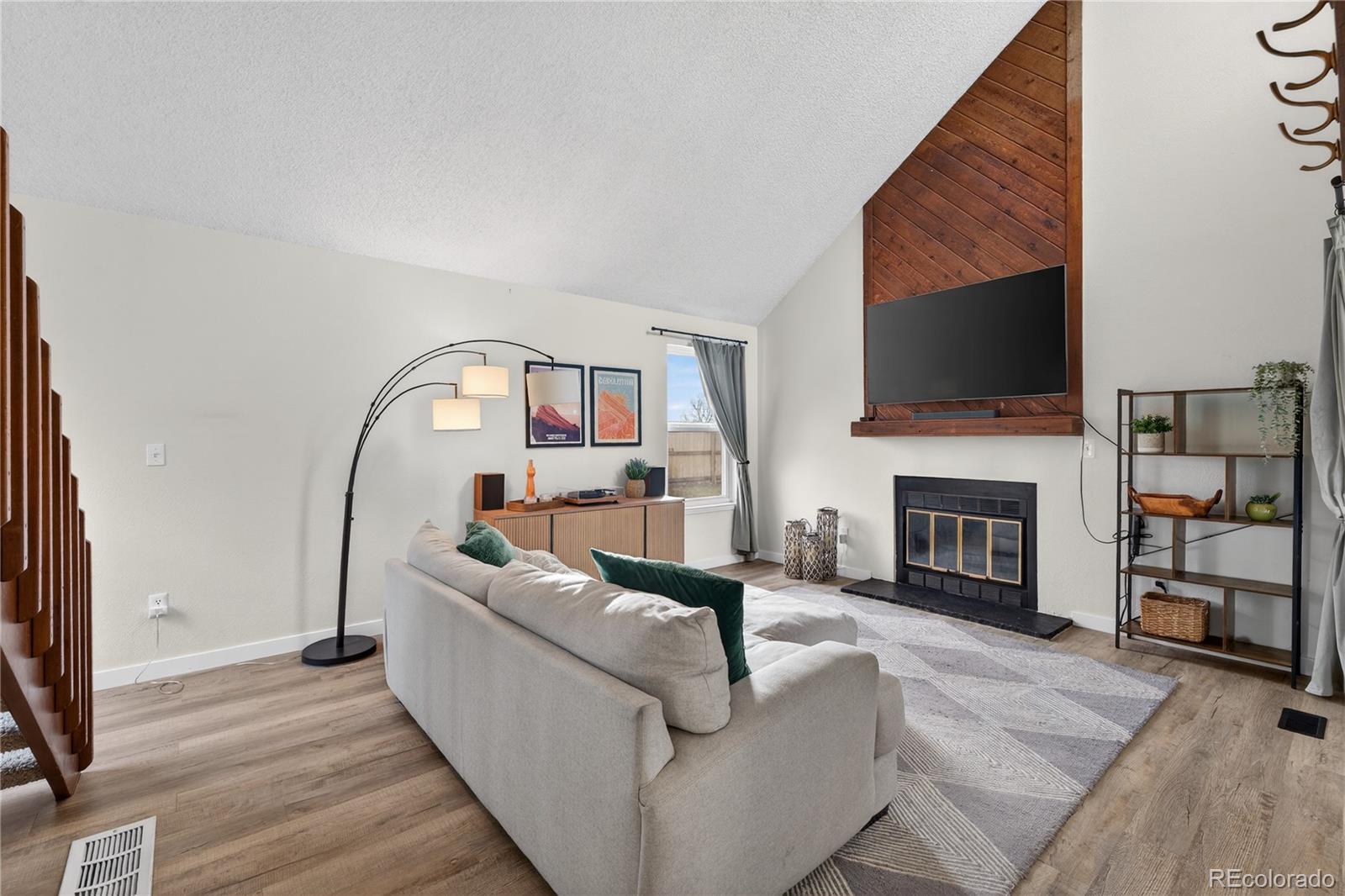 4730 Granby Way Denver, CO 80239 - Photo 6 of 27 a living room with furniture and a fireplace