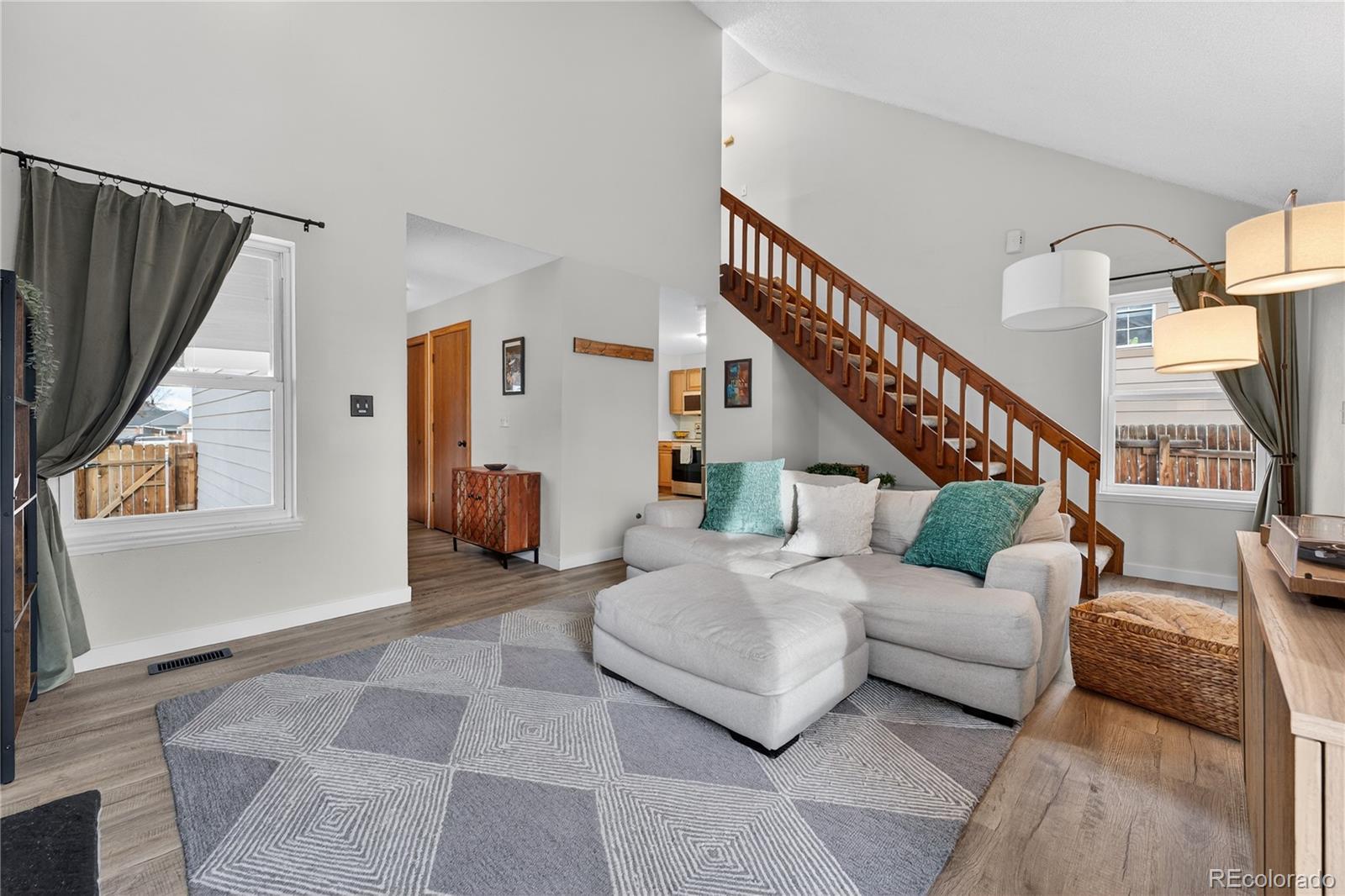 4730 Granby Way Denver, CO 80239 - Photo 9 of 27 a living room with furniture and stairs