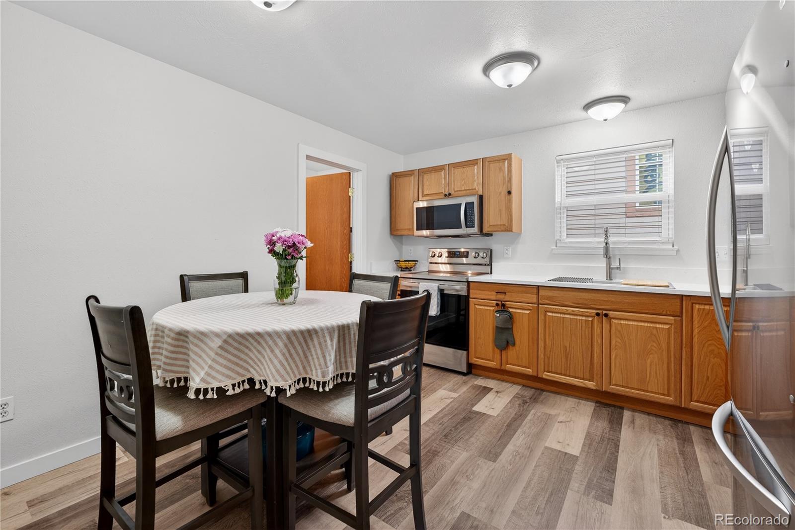 4730 Granby Way Denver, CO 80239 - Photo 10 of 27 a dining room with a sink table and chairs