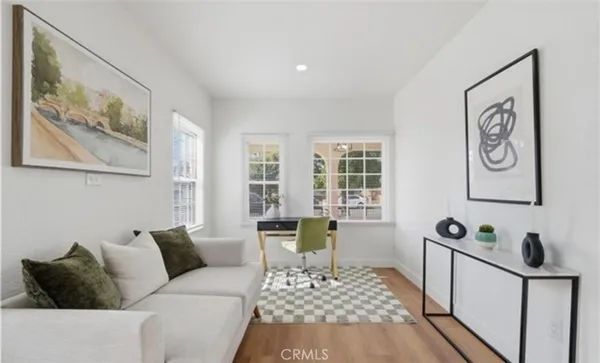 a living room with furniture and wooden floor