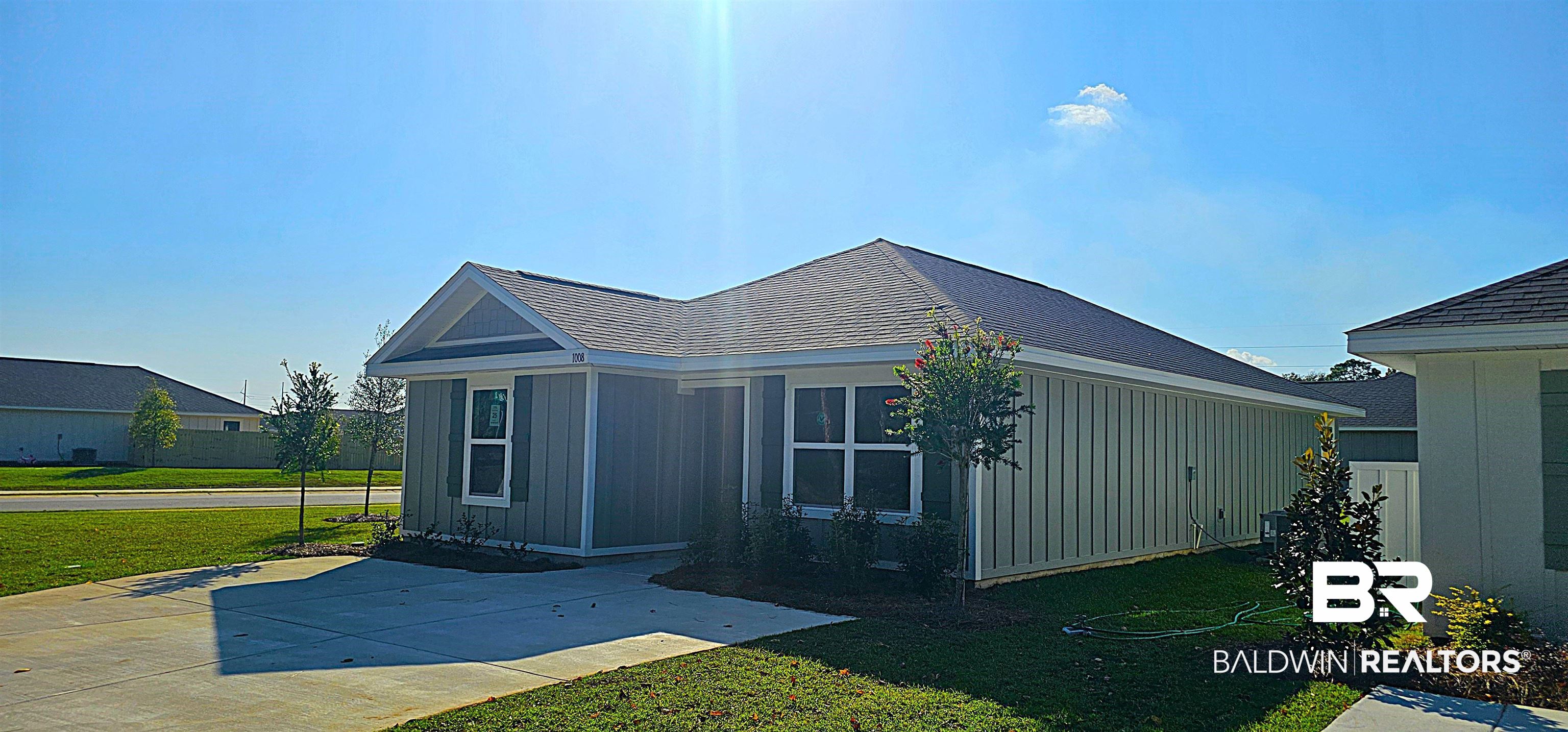 1008 South Bay Street Foley, AL 36535 - Photo 4 of 22 View of home's exterior featuring a yard and a patio area