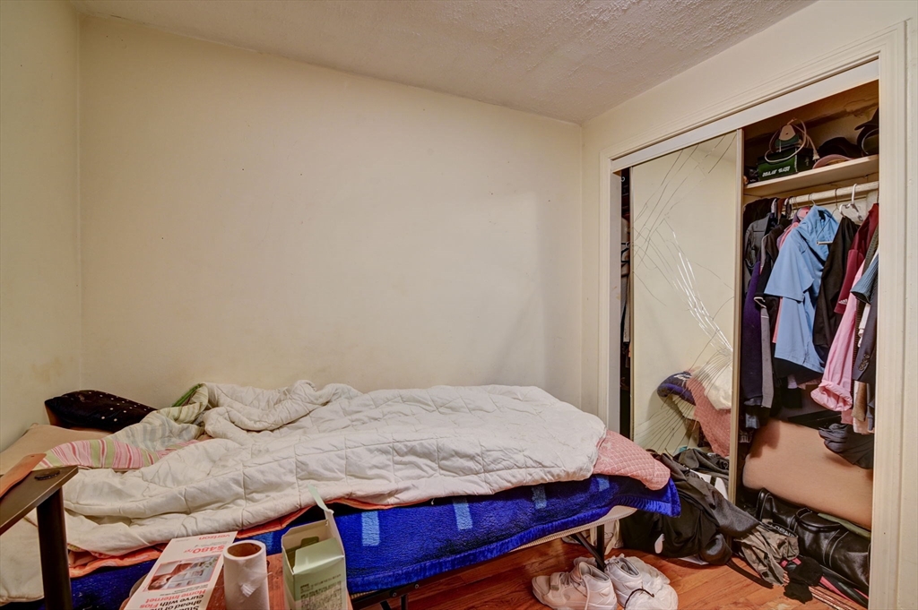 57 Brighton Avenue, Unit C Boston, MA 02134 - Photo 14 of 23 a bedroom with a bed and a window