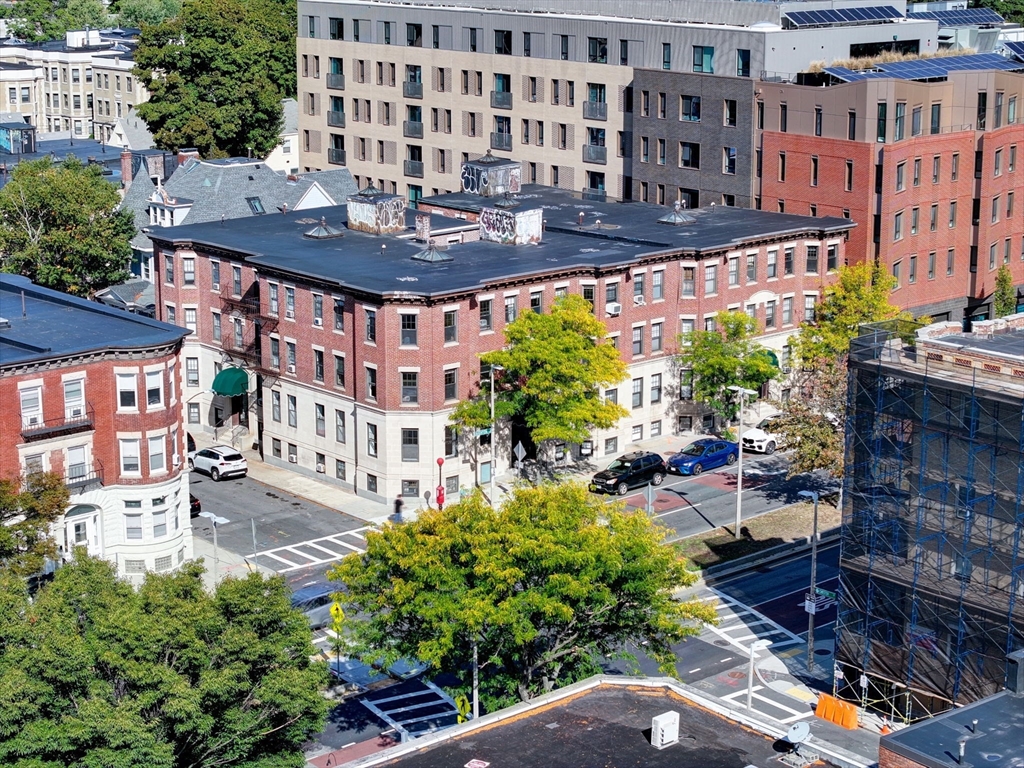 57 Brighton Avenue, Unit C Boston, MA 02134 - Photo 22 of 23 a view of a patio with table and chairs and potted plants