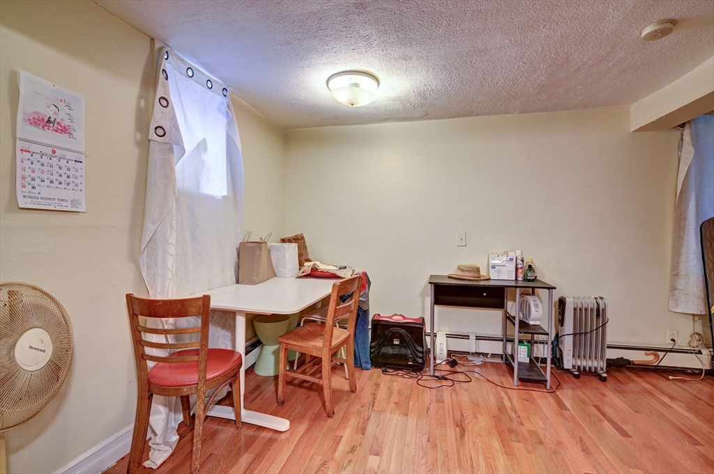 57 Brighton Avenue, Unit C Boston, MA 02134 - Photo 4 of 23 a view of a dining room with furniture and wooden floor