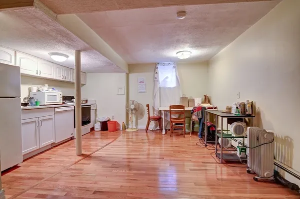 a living room with lots of furniture and kitchen view