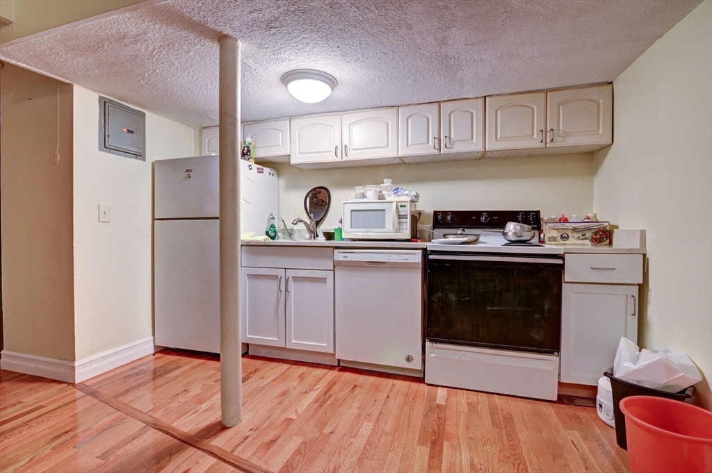 57 Brighton Avenue, Unit C Boston, MA 02134 - Photo 7 of 23 a kitchen with a stove and a refrigerator