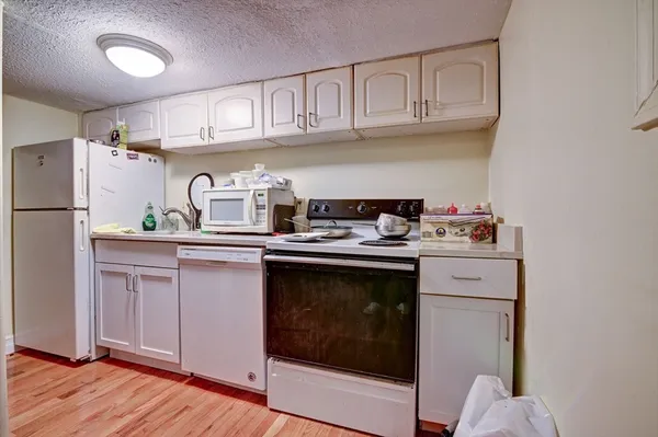 a kitchen with stainless steel appliances granite countertop a sink stove and cabinets