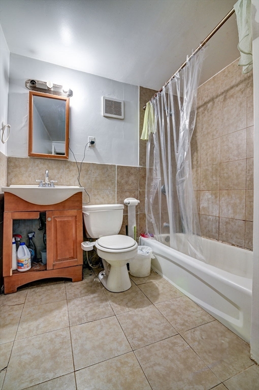 57 Brighton Avenue, Unit C Boston, MA 02134 - Photo 9 of 23 a bathroom with a toilet sink and mirror