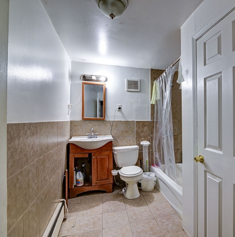 57 Brighton Avenue, Unit C Boston, MA 02134 - Photo 10 of 23 a bathroom with a toilet sink and mirror