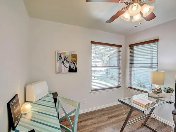 a view of a dining room with furniture and wooden floor