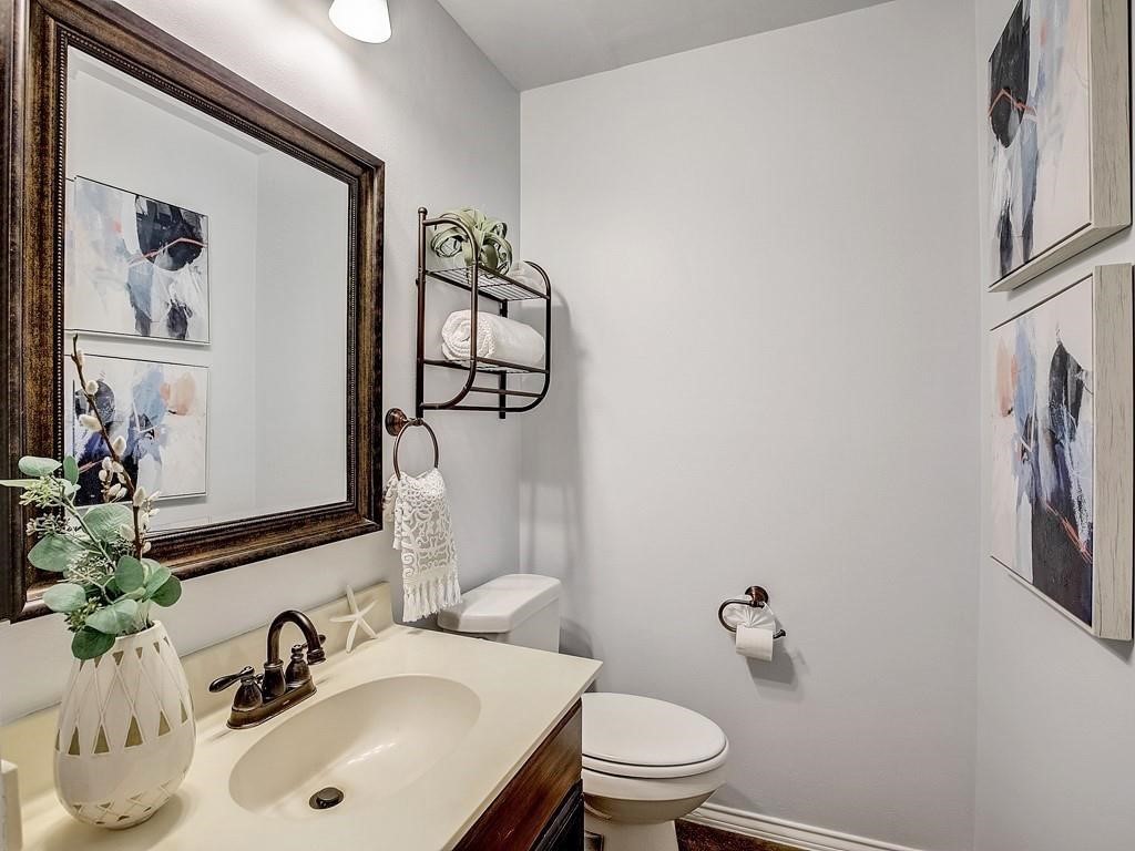12909 Modena Trail Austin, TX 78729 - Photo 17 of 26 a bathroom with a sink toilet and mirror