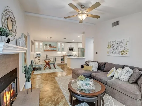 a living room with furniture and a fireplace