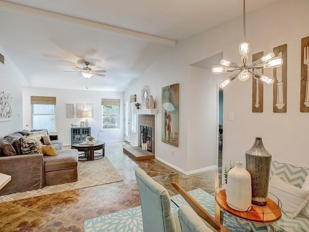 12909 Modena Trail Austin, TX 78729 - Photo 6 of 26 a living room with furniture a chandelier and a flat screen tv