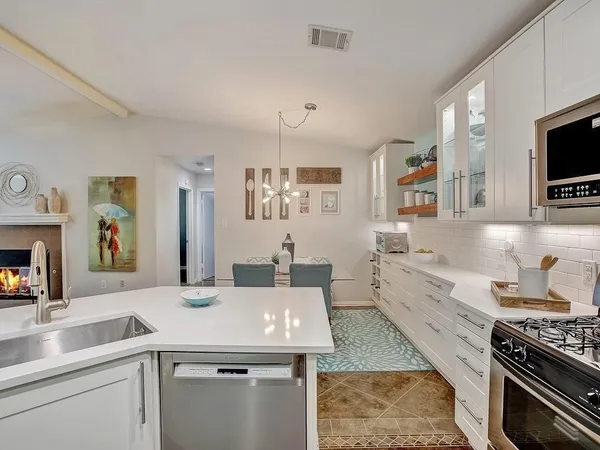a kitchen with a sink stove and microwave