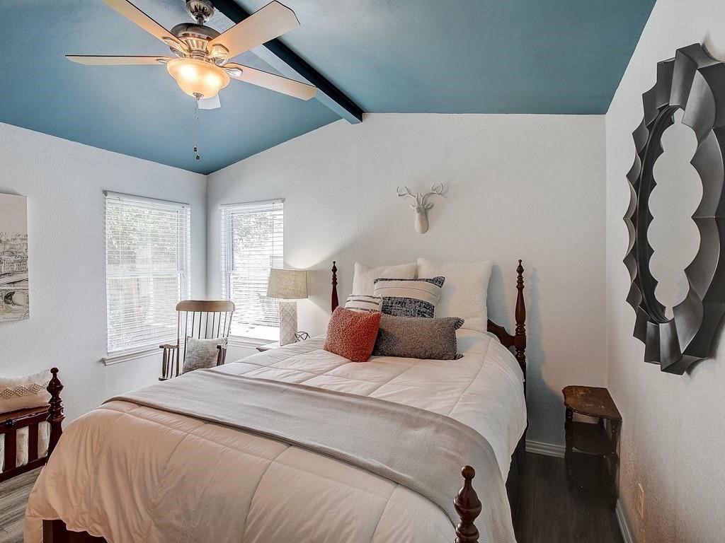 12909 Modena Trail Austin, TX 78729 - Photo 10 of 26 a bedroom with a bed and a chandelier