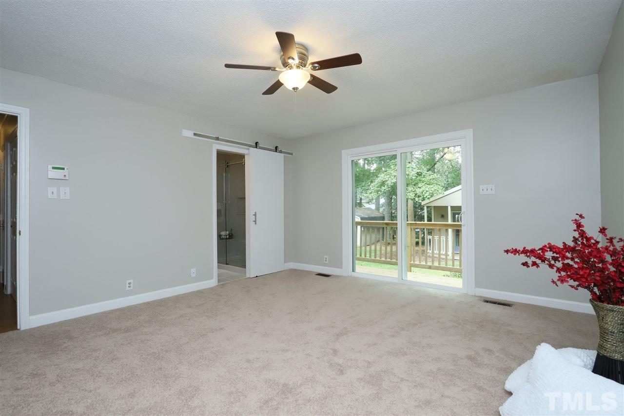 4101 Stranaver Place Raleigh, NC 27612 - Photo 14 of 27 Spacious Master Suite with ceiling fan and sliding door opening to deck.