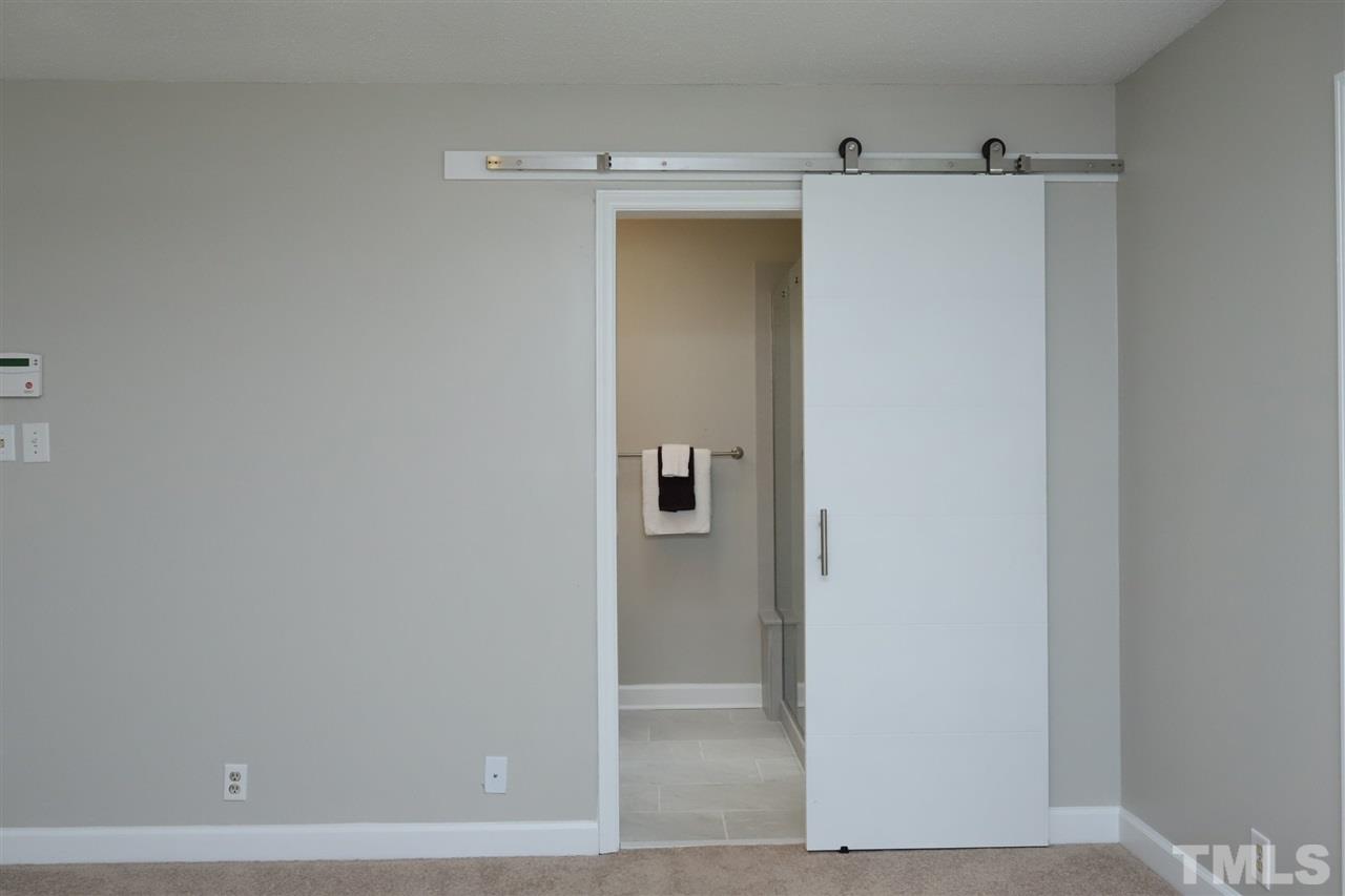 4101 Stranaver Place Raleigh, NC 27612 - Photo 16 of 27 Trendy barn-door entry into Master Bath.