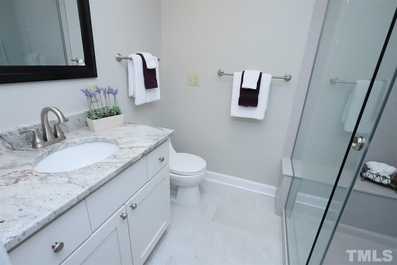 4101 Stranaver Place Raleigh, NC 27612 - Photo 17 of 27 Nicely updated Master Bath with granite vanity top, ceramic floor and large walk-in shower.