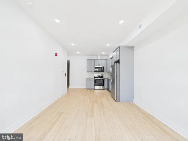 a view of kitchen with refrigerator and window