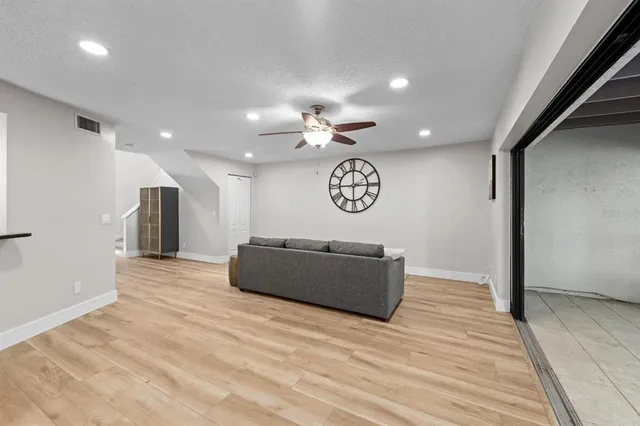 a view of a room with a window and wooden floor