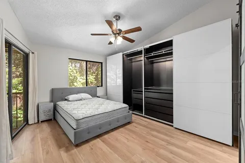 a bedroom with a large bed and a window