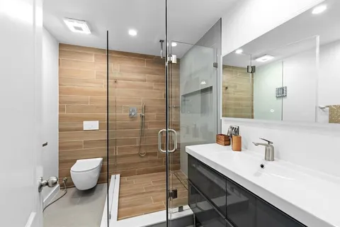 a bathroom with a sink toilet and shower