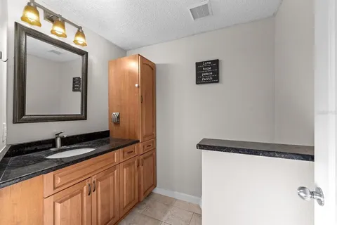 a bathroom with a double vanity sink and a mirror