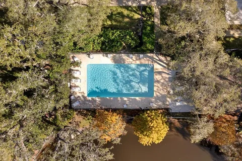 an aerial view of a residential houses with yard