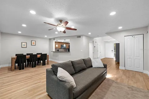 a living room with furniture and wooden floor