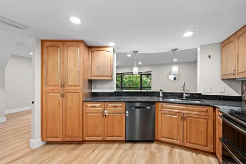 a kitchen with stainless steel appliances granite countertop a sink and cabinets