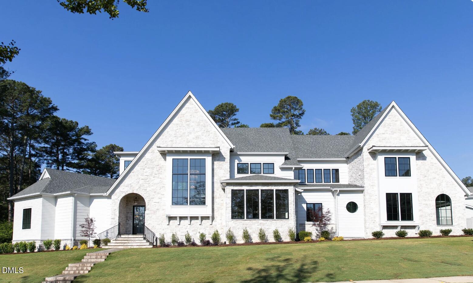7425 Grist Mill Road Raleigh, NC 27615 - Photo 1 of 57 a front view of a house with a garden