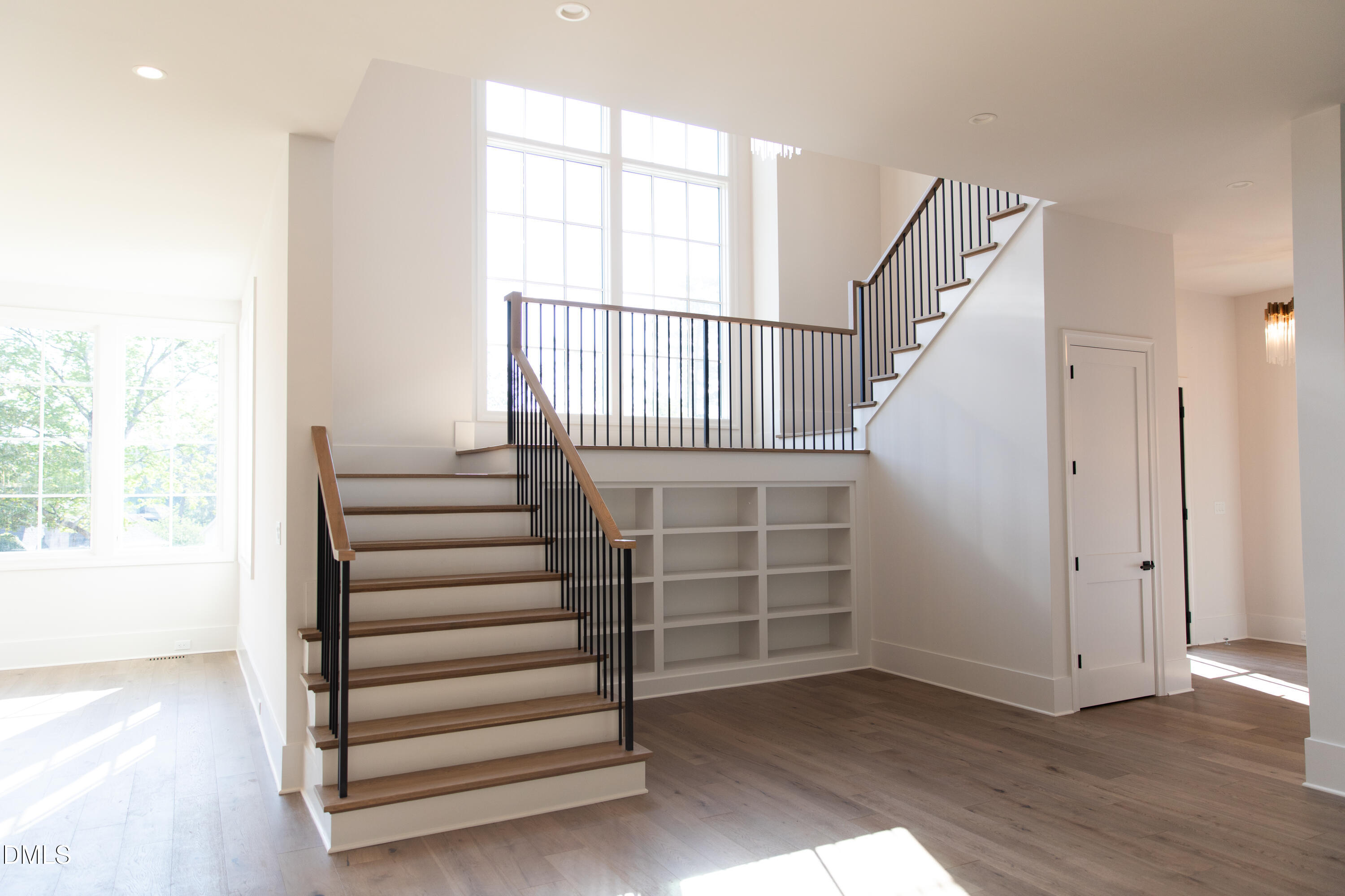 7425 Grist Mill Road Raleigh, NC 27615 - Photo 10 of 57 a view of entryway with stairs and wooden floor