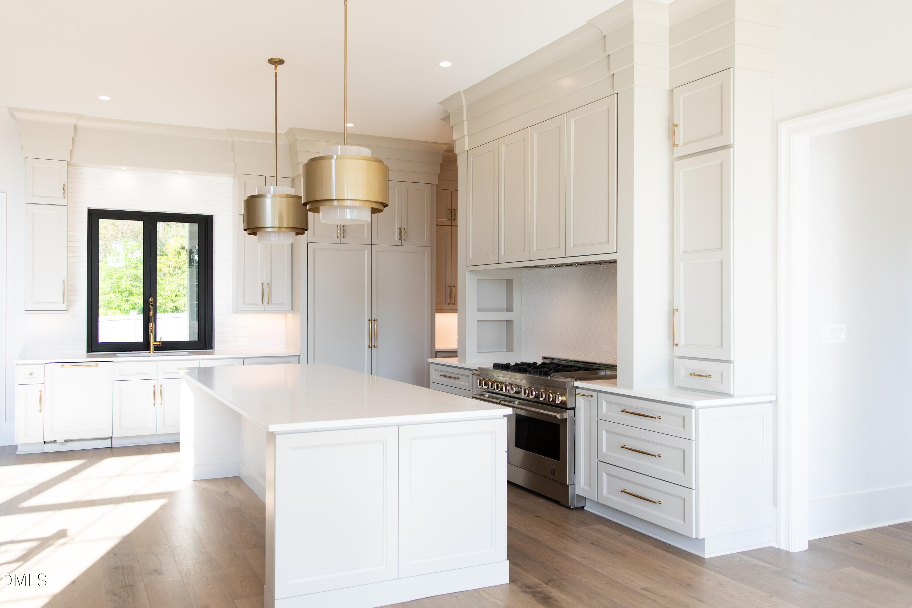 7425 Grist Mill Road Raleigh, NC 27615 - Photo 19 of 57 a kitchen with a stove a refrigerator and a sink