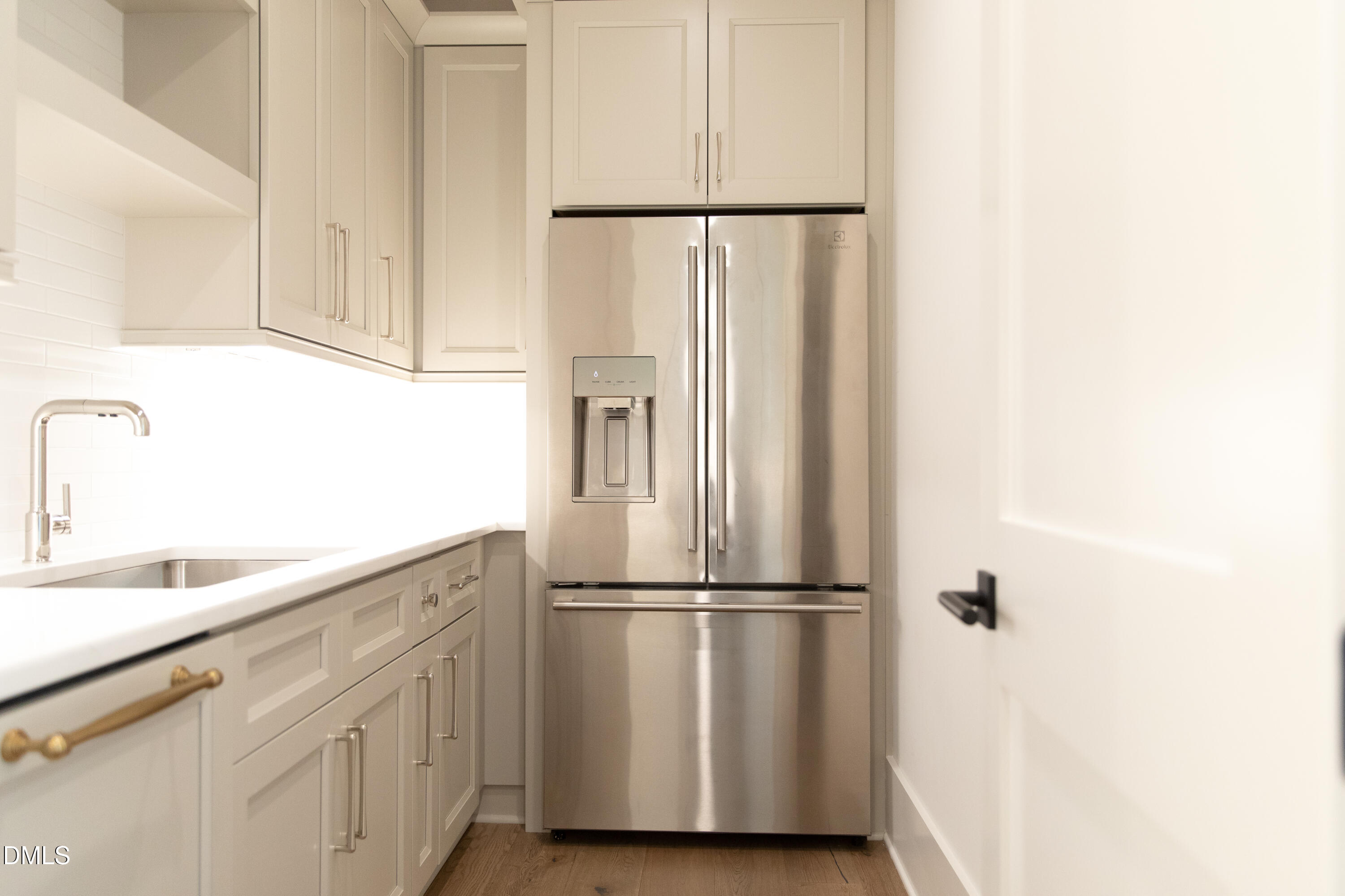 7425 Grist Mill Road Raleigh, NC 27615 - Photo 27 of 57 a kitchen with a refrigerator and cabinets