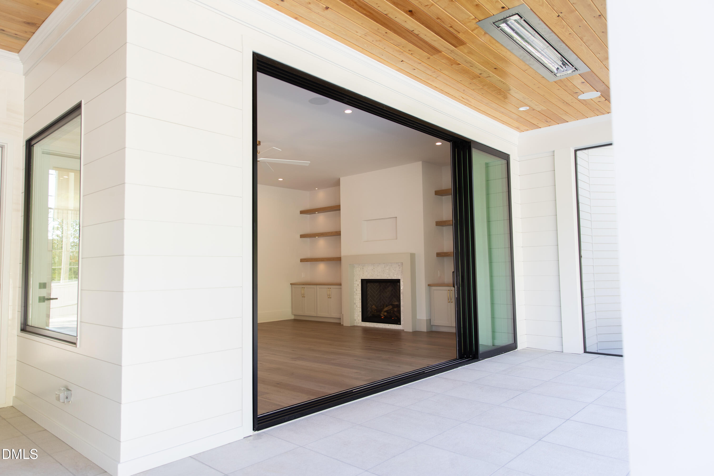 7425 Grist Mill Road Raleigh, NC 27615 - Photo 31 of 57 a view of a hallway with wooden floor and a fireplace