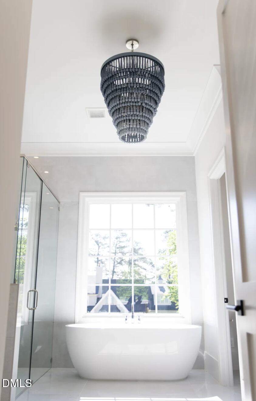 7425 Grist Mill Road Raleigh, NC 27615 - Photo 33 of 57 a view of bathroom with bathtub and shower