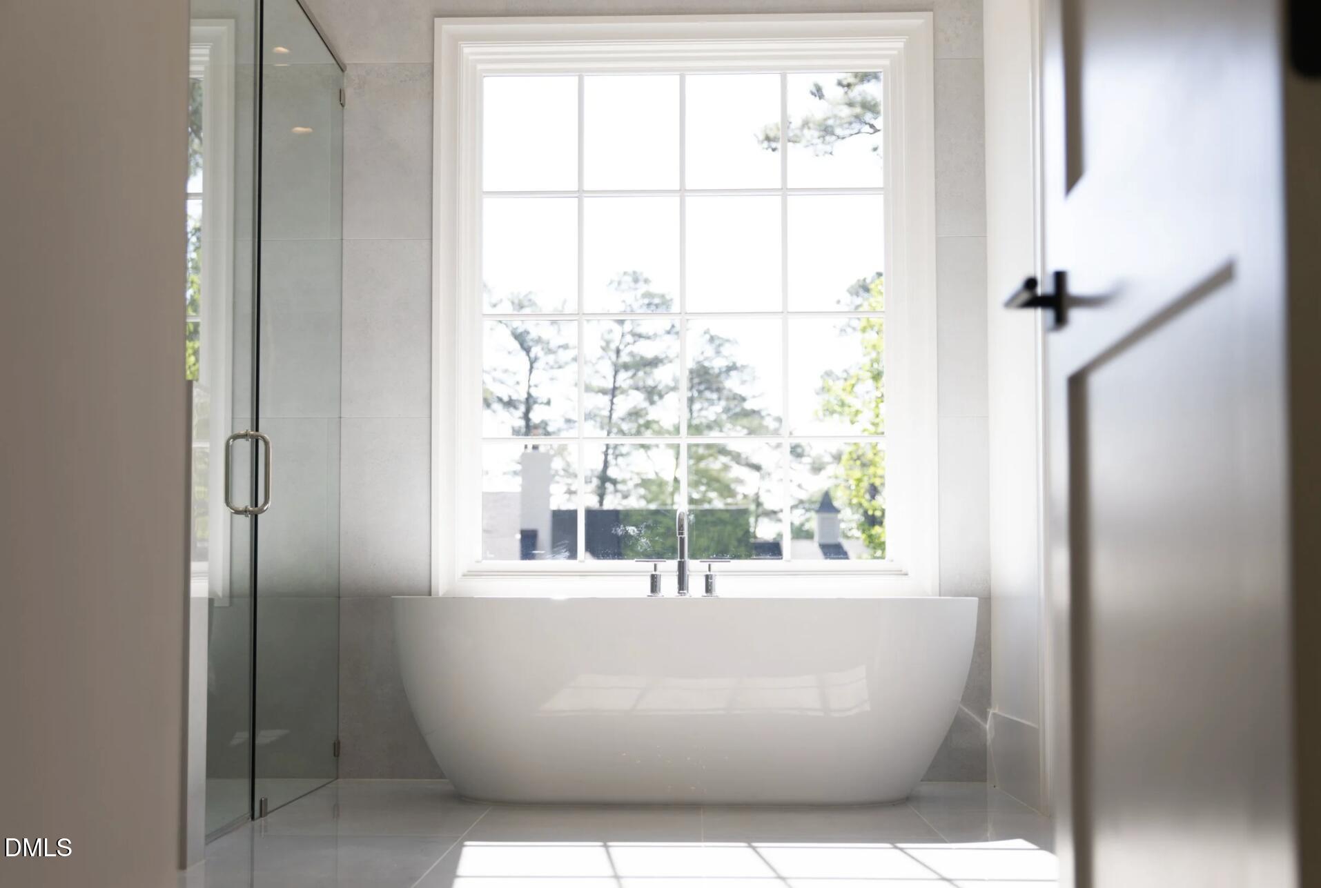 7425 Grist Mill Road Raleigh, NC 27615 - Photo 34 of 57 a white tub sitting next to a window