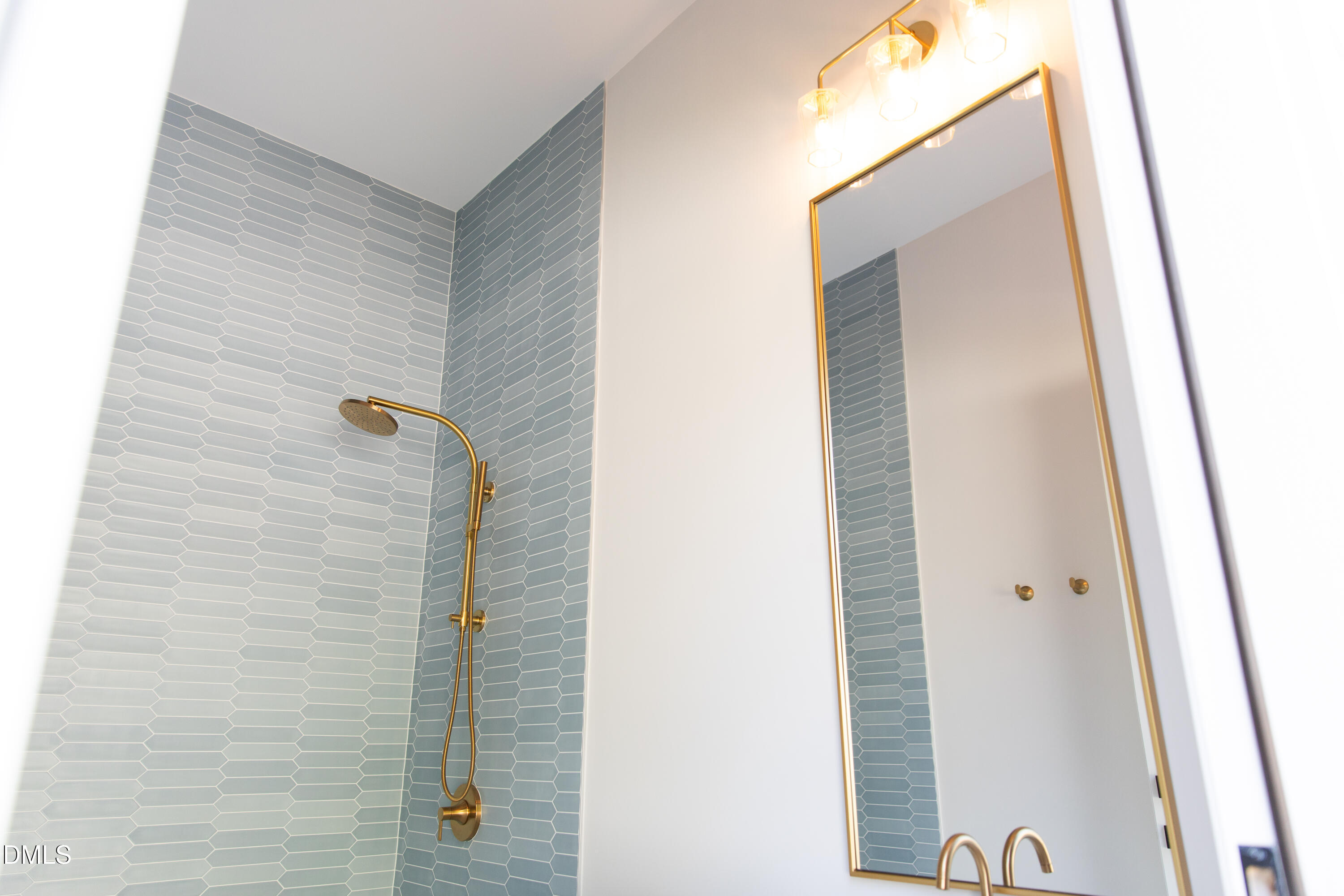 7425 Grist Mill Road Raleigh, NC 27615 - Photo 49 of 57 a bathroom with a shower and a mirror