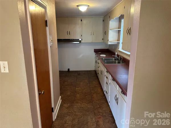 a kitchen with granite countertop a refrigerator and a stove