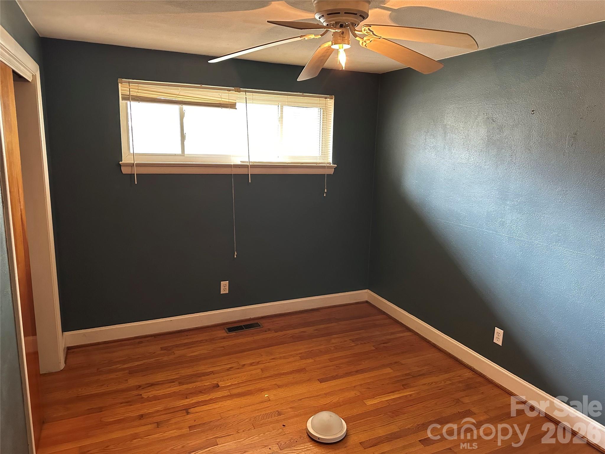 5164 Lavern Street, Unit 1 Conover, NC 28613 - Photo 18 of 28 an empty room with wooden floor and windows