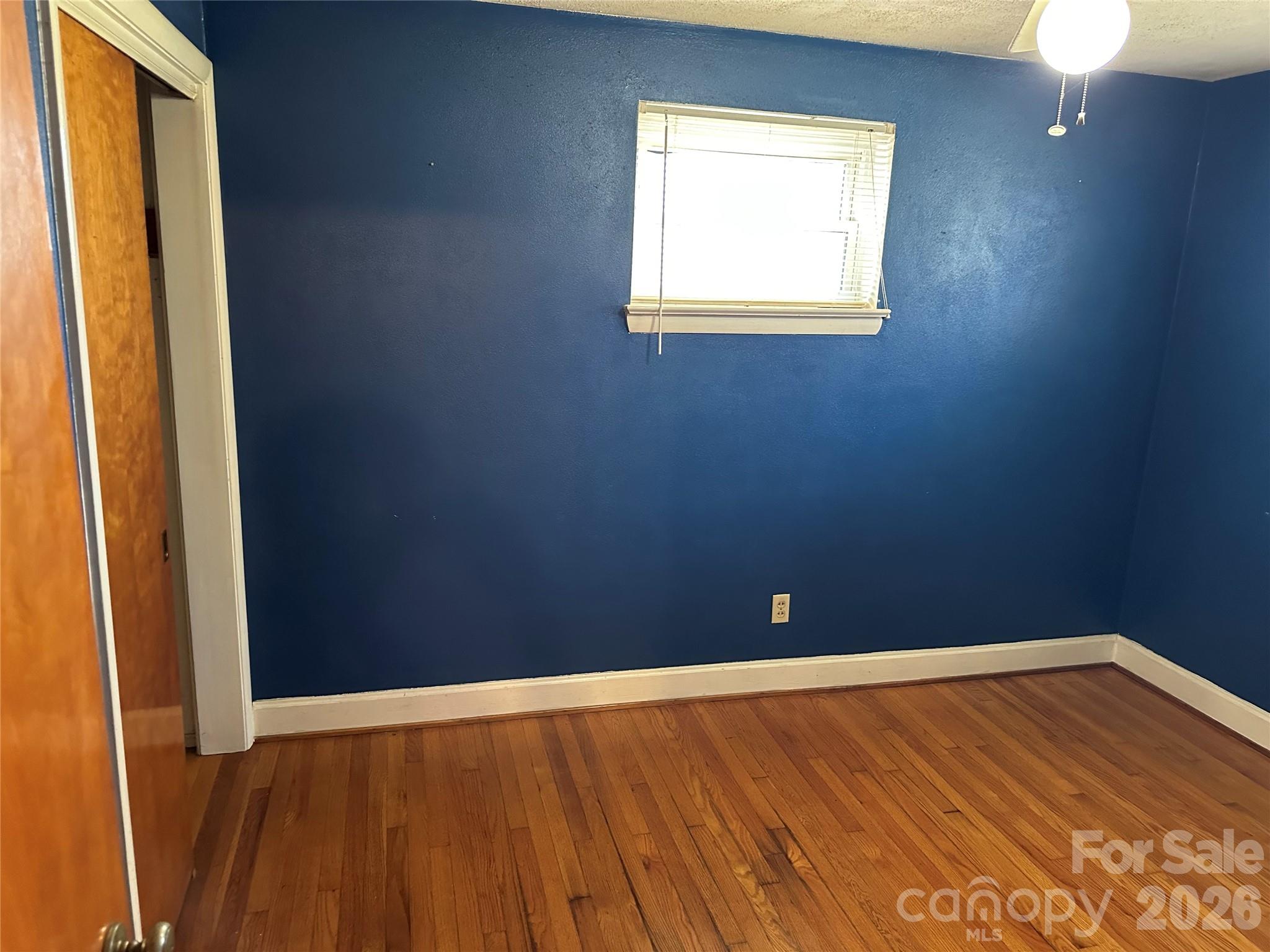 5164 Lavern Street, Unit 1 Conover, NC 28613 - Photo 20 of 28 a view of an empty room with wooden floor and a window