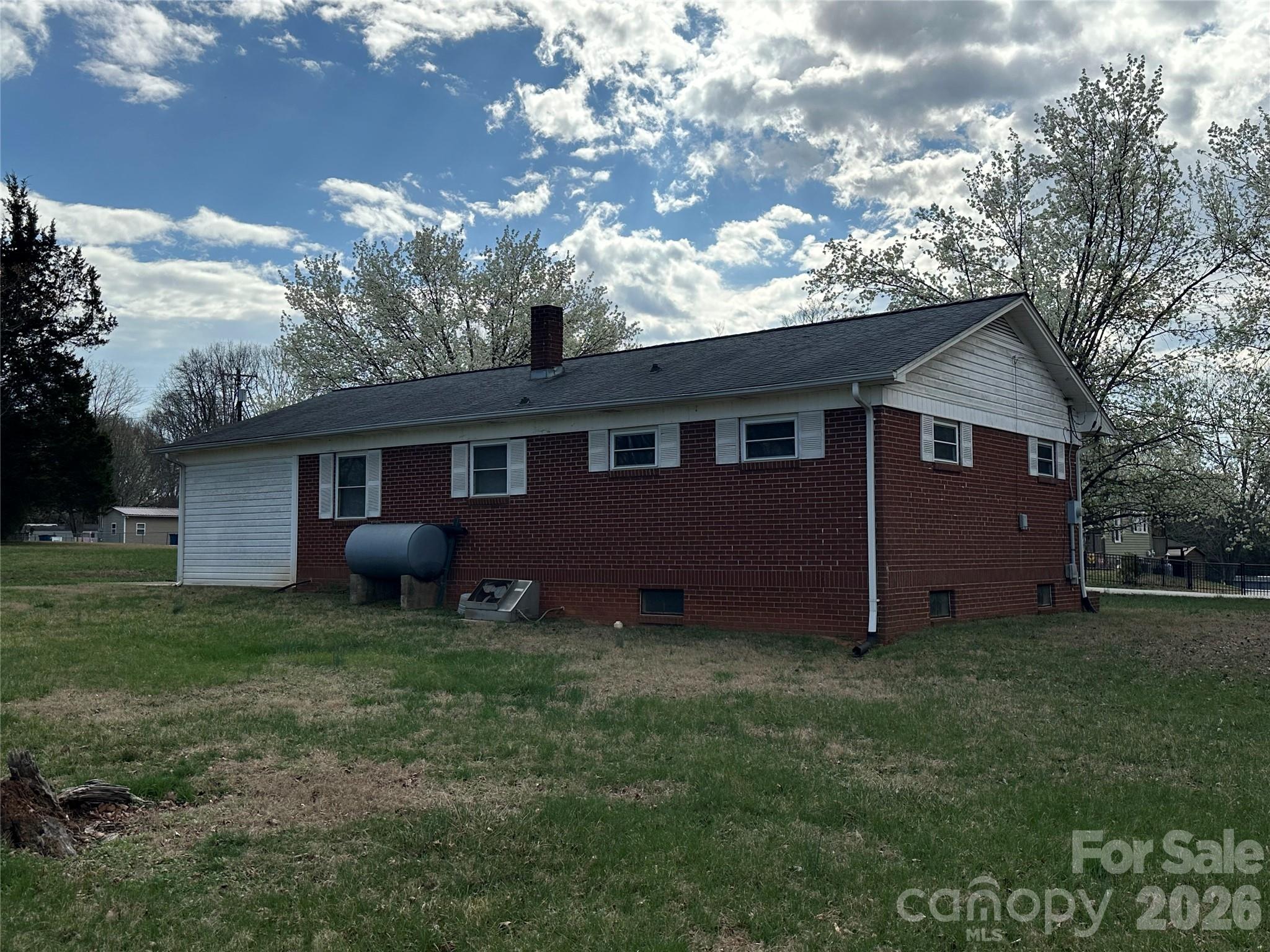 5164 Lavern Street, Unit 1 Conover, NC 28613 - Photo 8 of 28 a view of a house with a yard tree and a fire pit