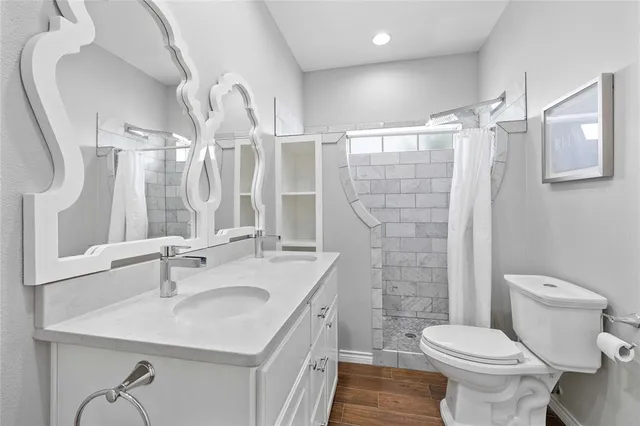a bathroom with a sink toilet and shower