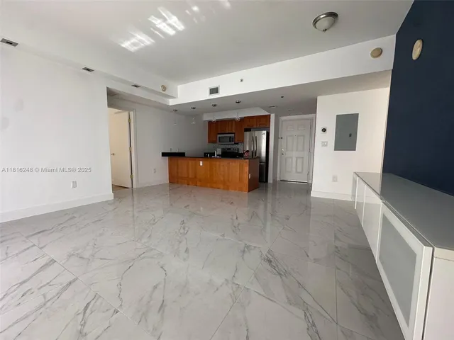 a kitchen with stainless steel appliances granite countertop a refrigerator and a stove